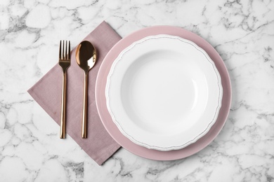 Photo of Beautiful table setting on white marble background, flat lay