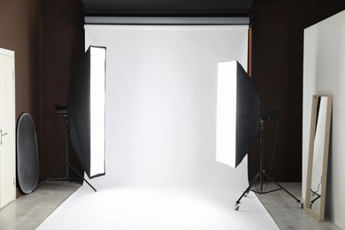 Photo of White photo background and professional lighting equipment in studio