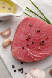 Raw tuna fillet and spices on table, flat lay