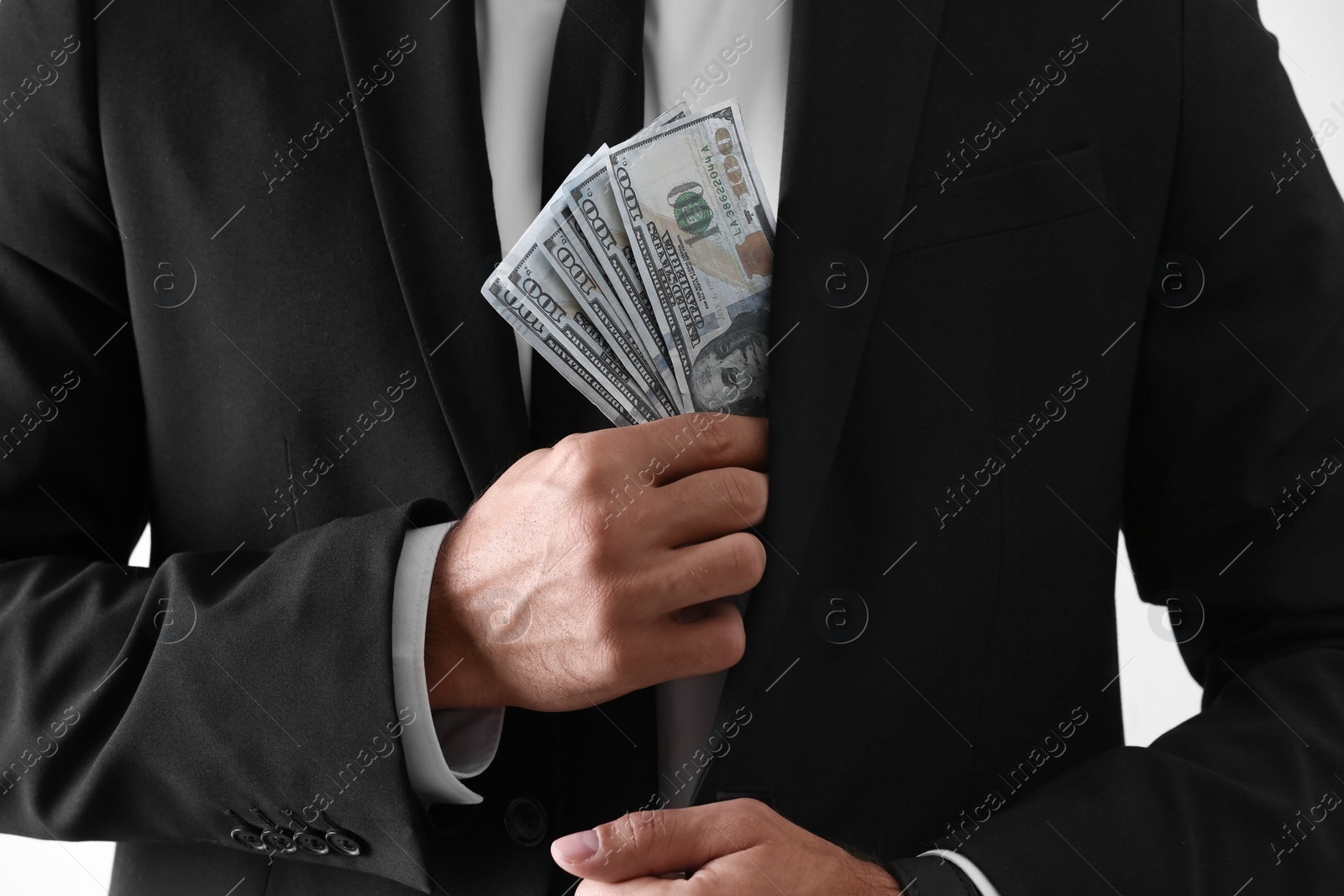 Photo of Man with bribe money on light background, closeup