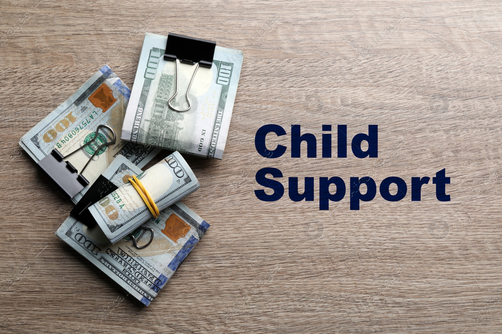 Image of Child support concept. Many dollar banknotes on wooden table, flat lay