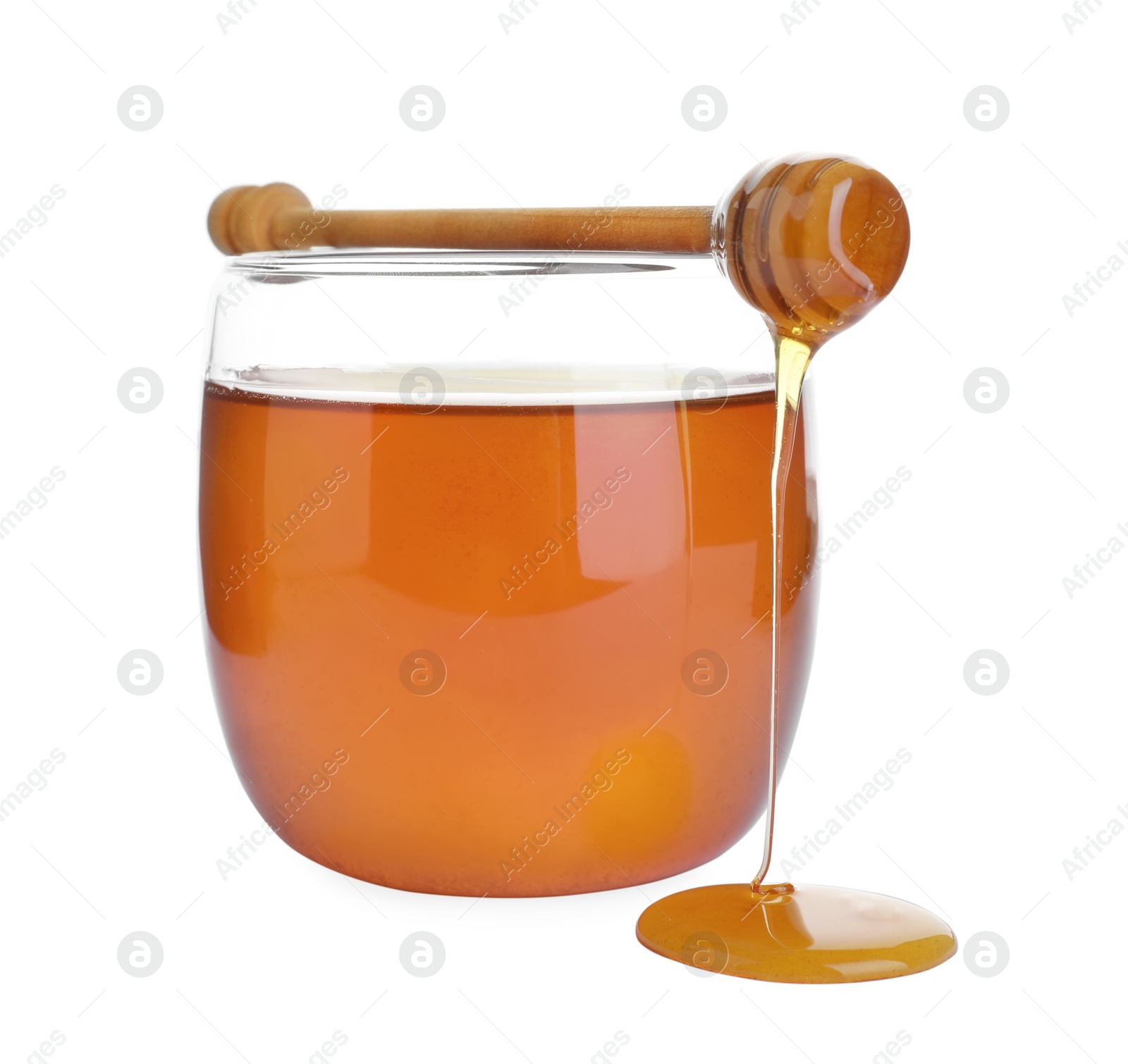 Photo of Glass jar of wildflower honey and wooden dipper isolated on white