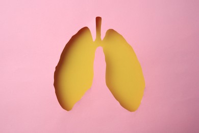 Photo of Pink paper with hole in shape of human lungs, top view