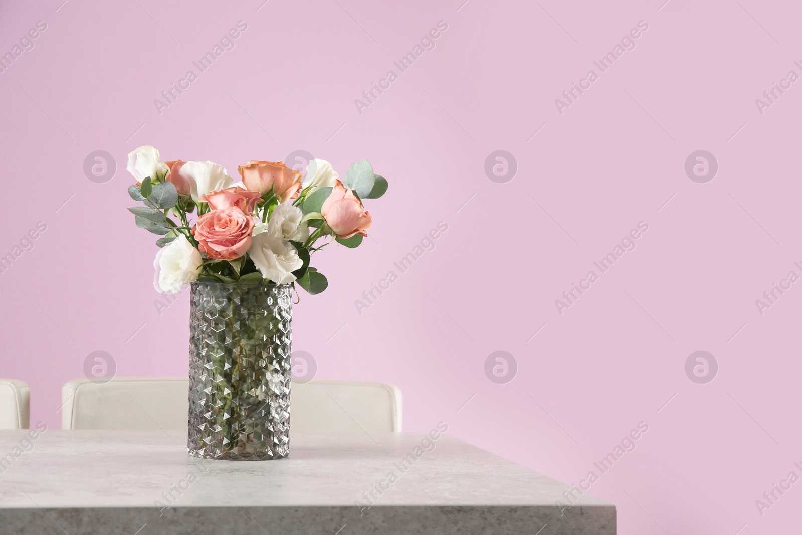 Photo of Vase with beautiful flowers as element of interior design on table in room. Space for text