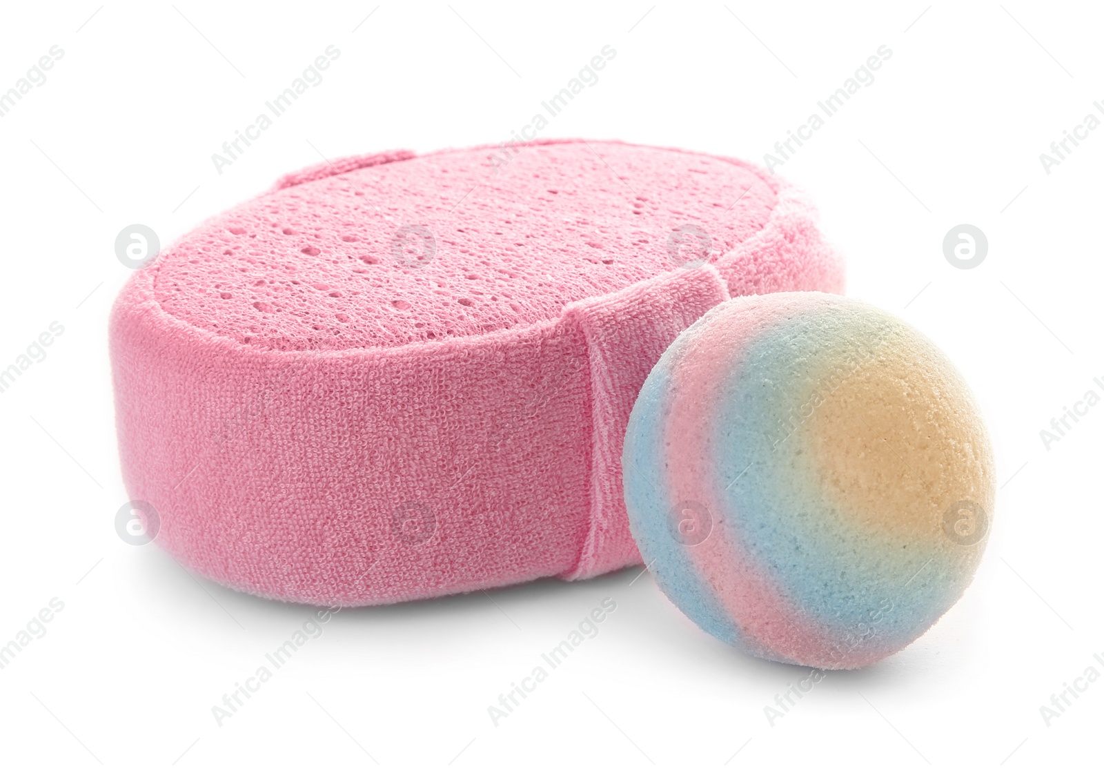 Photo of Pink sponge and bath bomb on white background