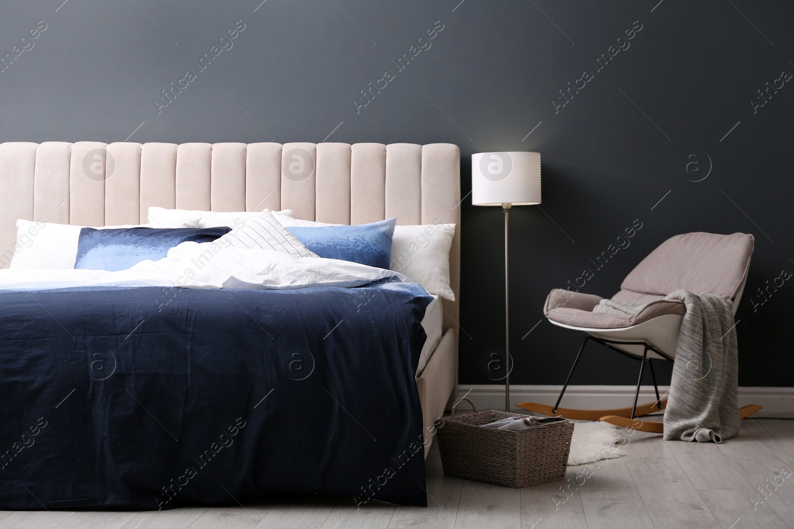 Photo of Comfortable bed with pillows and soft blanket in room. Stylish interior design