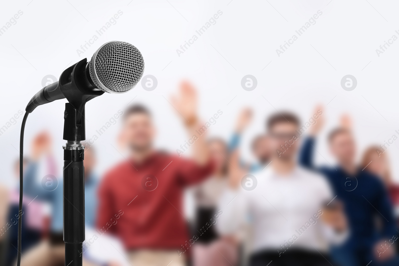 Image of Modern microphone and people at business training indoors, closeup