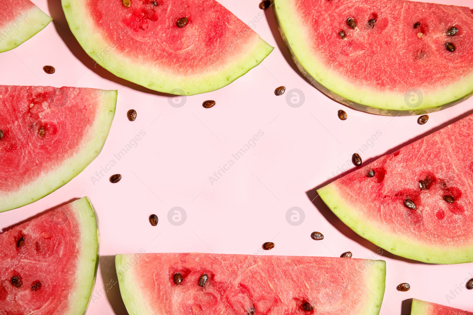 Photo of Frame of watermelon slices on pink background, flat lay. Space for text