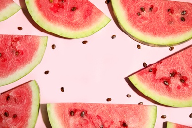 Frame of watermelon slices on pink background, flat lay. Space for text