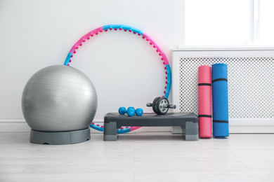 Photo of Different sports equipment near white wall in gym