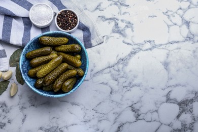 Photo of Bowl of pickled cucumbers and ingredients on white marble table, flat lay. Space for text