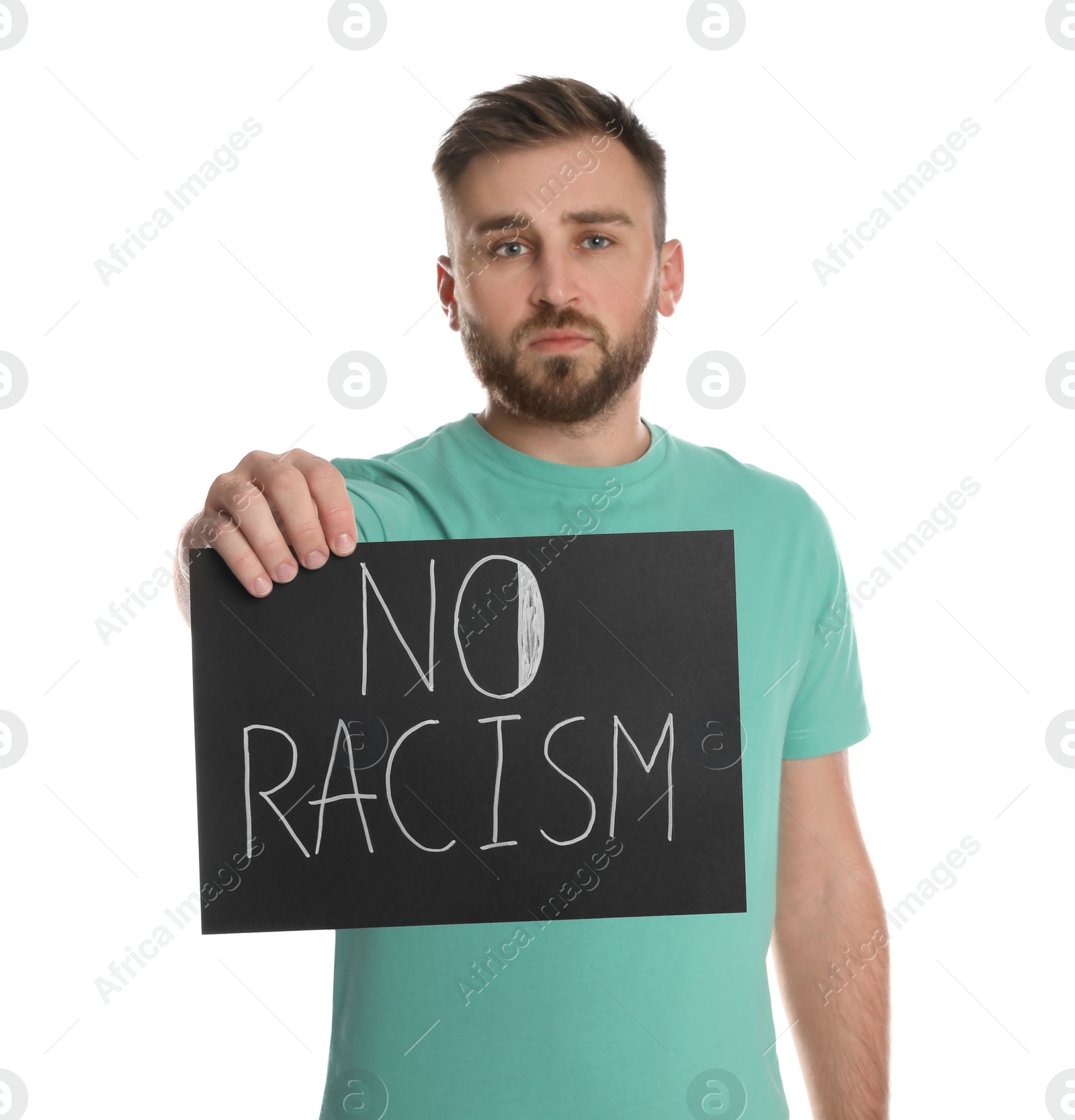 Photo of Young man holding sign with phrase No Racism on white background