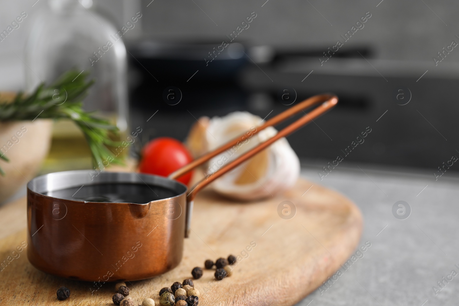 Photo of Organic balsamic vinegar and cooking ingredients on grey table. Space for text