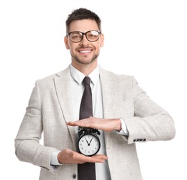 Photo of Happy businessman holding alarm clock on white background. Time management