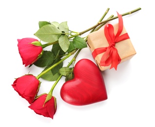 Photo of Beautiful gift box, roses and red heart on white background, top view. Valentine's day celebration