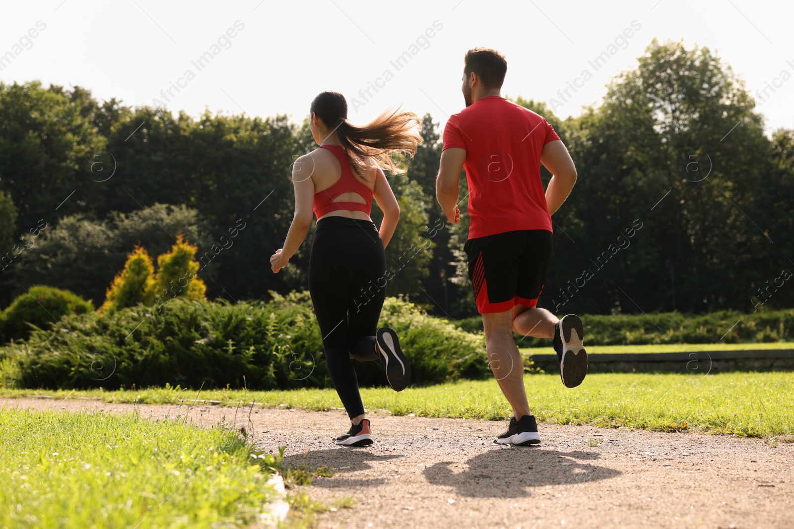 Photo of Healthy lifestyle. Couple running in park, low angle view