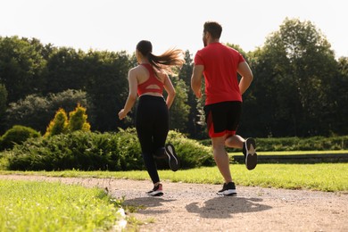 Photo of Healthy lifestyle. Couple running in park, low angle view