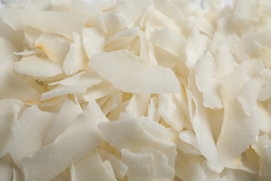 Photo of Delicious fresh coconut chips as background, closeup