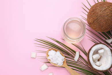 Flat lay composition with coconut oil on pink background, space for text