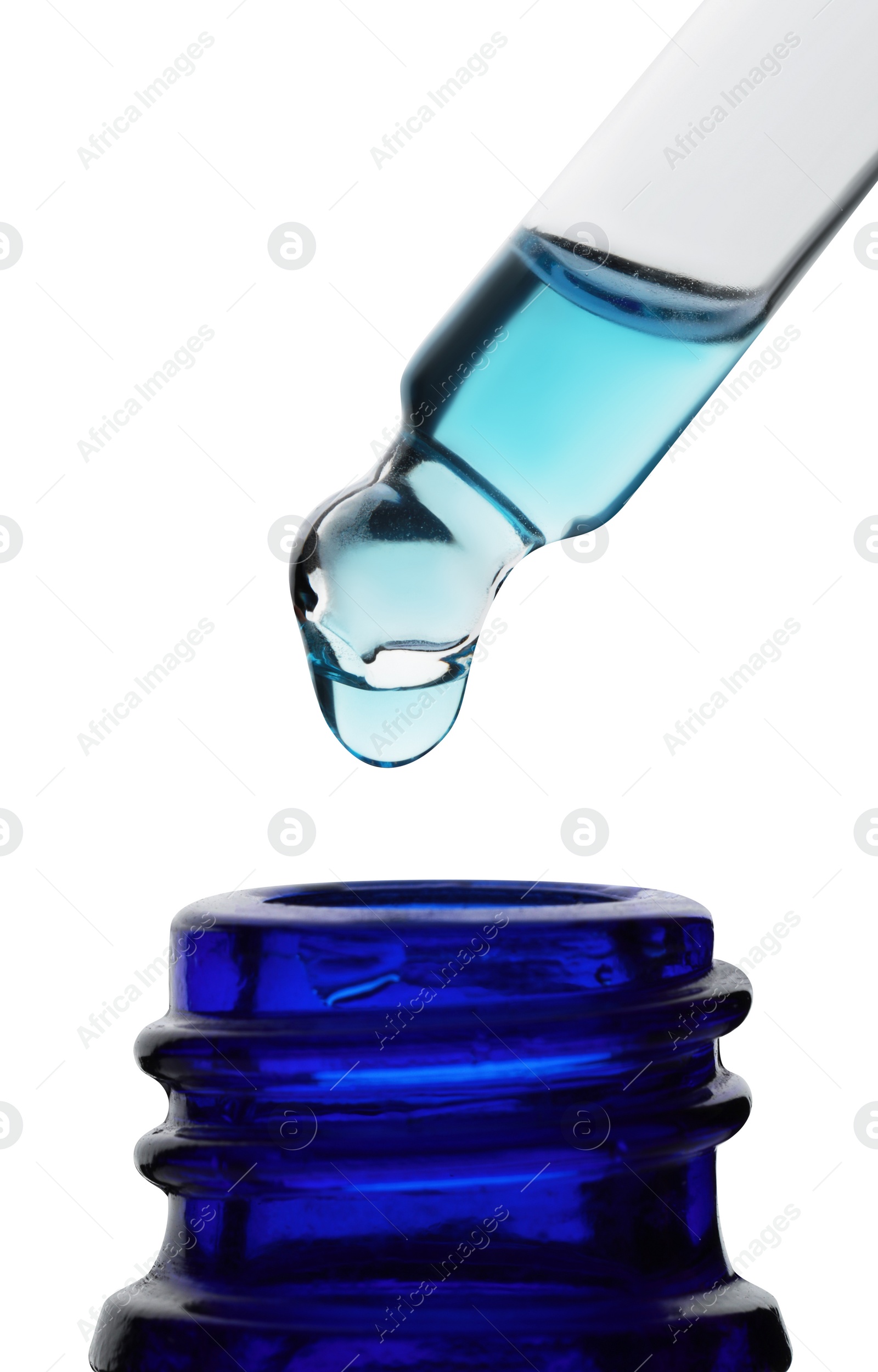 Photo of Dripping light blue facial serum from pipette into glass bottle on white background, closeup