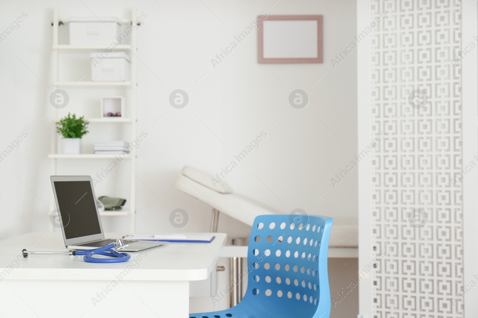 Photo of Doctor's workplace with modern laptop in medical office