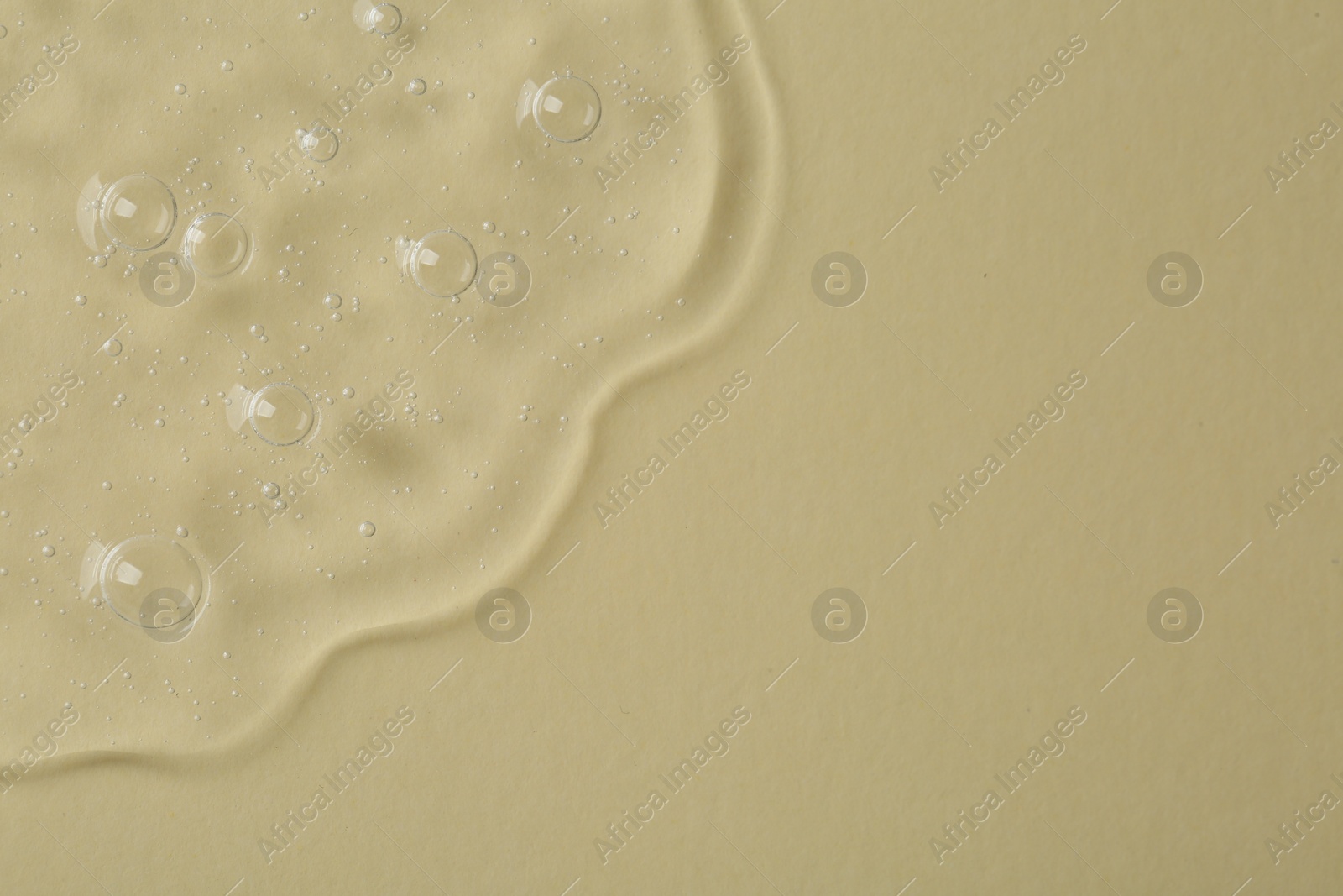 Photo of Cosmetic serum on beige background, top view. Space for text
