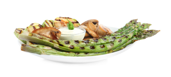 Photo of Tasty grilled asparagus with sauce, zucchini and mushrooms isolated on white
