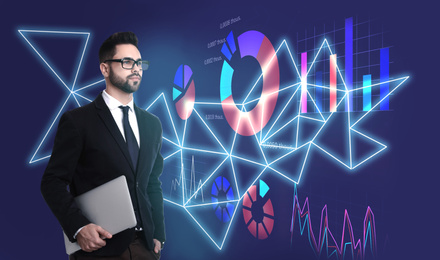 Image of Young businessman holding laptop and virtual screen with different schemes on background. Finance trading concept