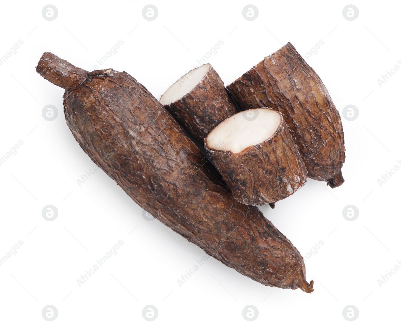 Photo of Whole and cut cassava roots isolated on white, top view