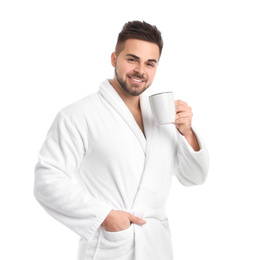 Handsome man in bathrobe with cup of coffee on white background