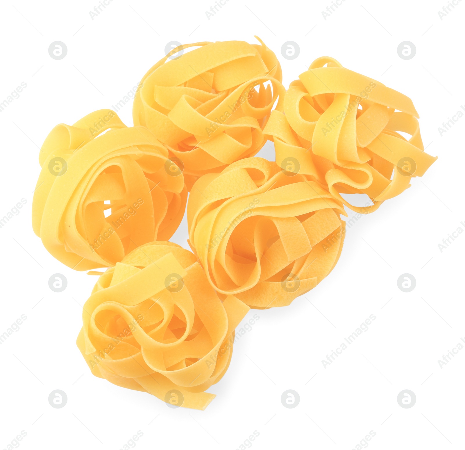 Photo of Raw fettuccine pasta isolated on white, top view