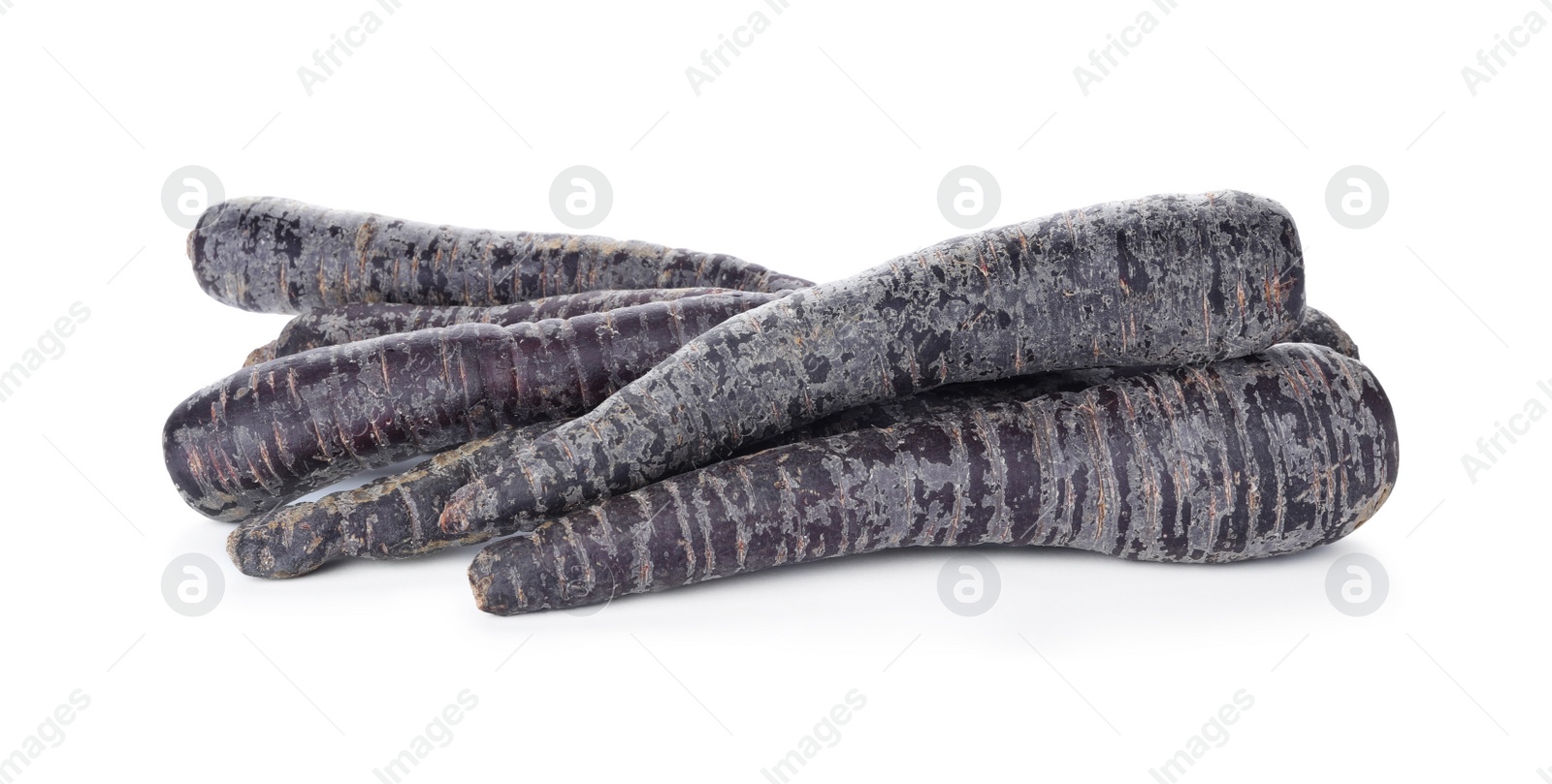 Photo of Fresh raw black carrots isolated on white