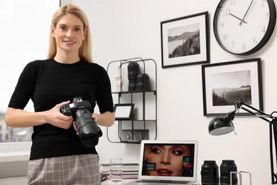 Professional photographer with modern digital camera in office