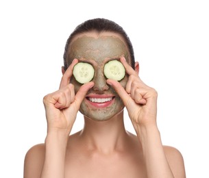 Photo of Beautiful woman with clay mask covering eyes with pieces of cucumber on white background