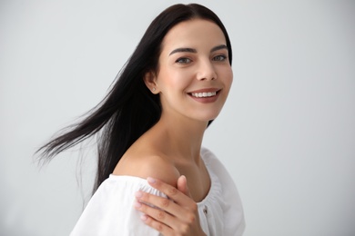 Photo of Beautiful young woman on light grey background