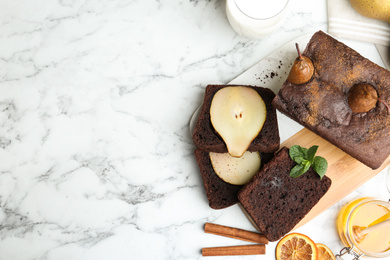 Flat lay composition with tasty pear bread on white marble table, space for text. Homemade cake