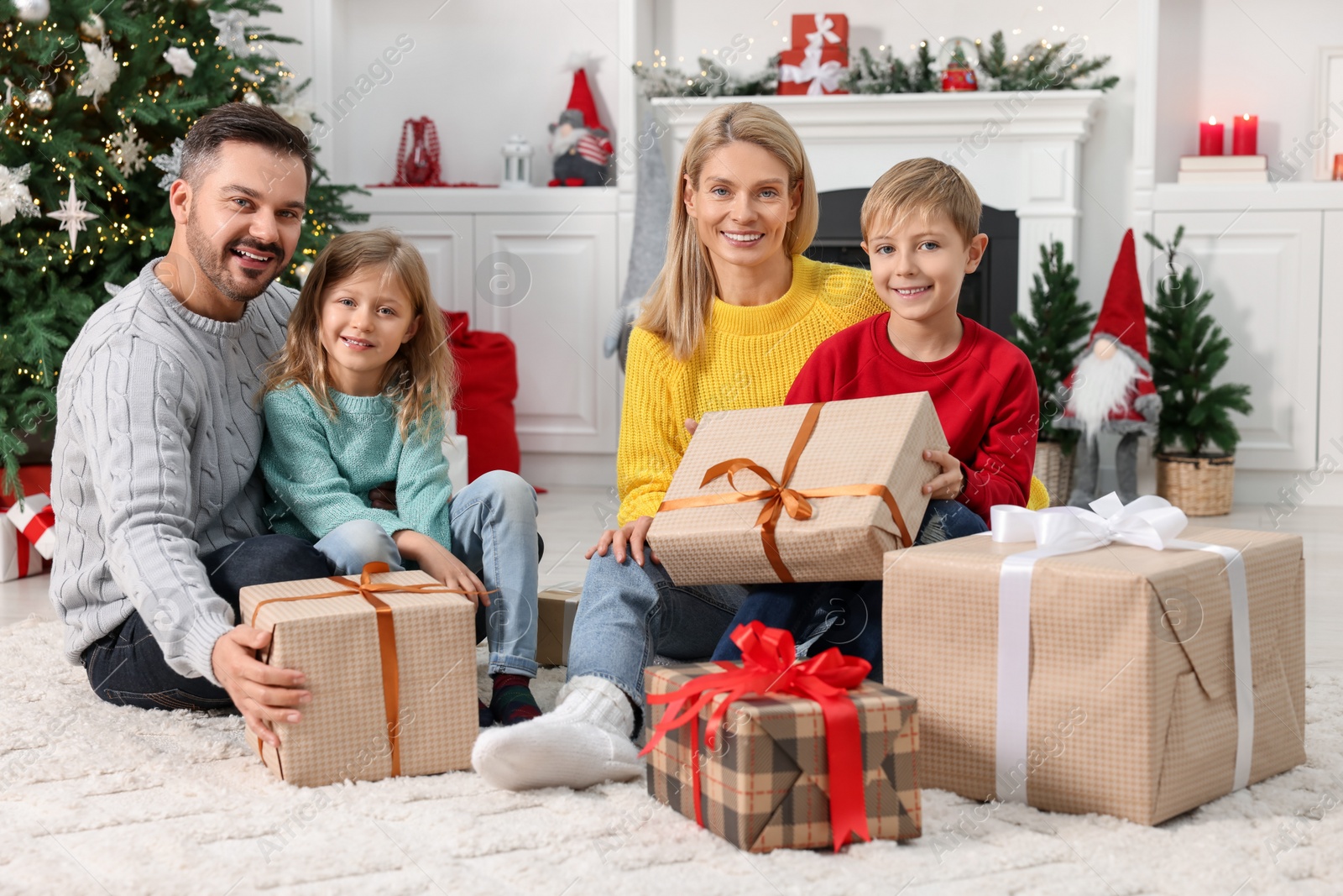 Photo of Happy family with Christmas gifts at home