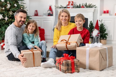 Photo of Happy family with Christmas gifts at home