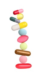 Stack of different colorful pills on white background