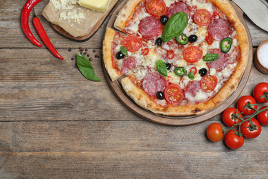 Photo of Delicious pizza Diablo on wooden table, flat lay. Space for text