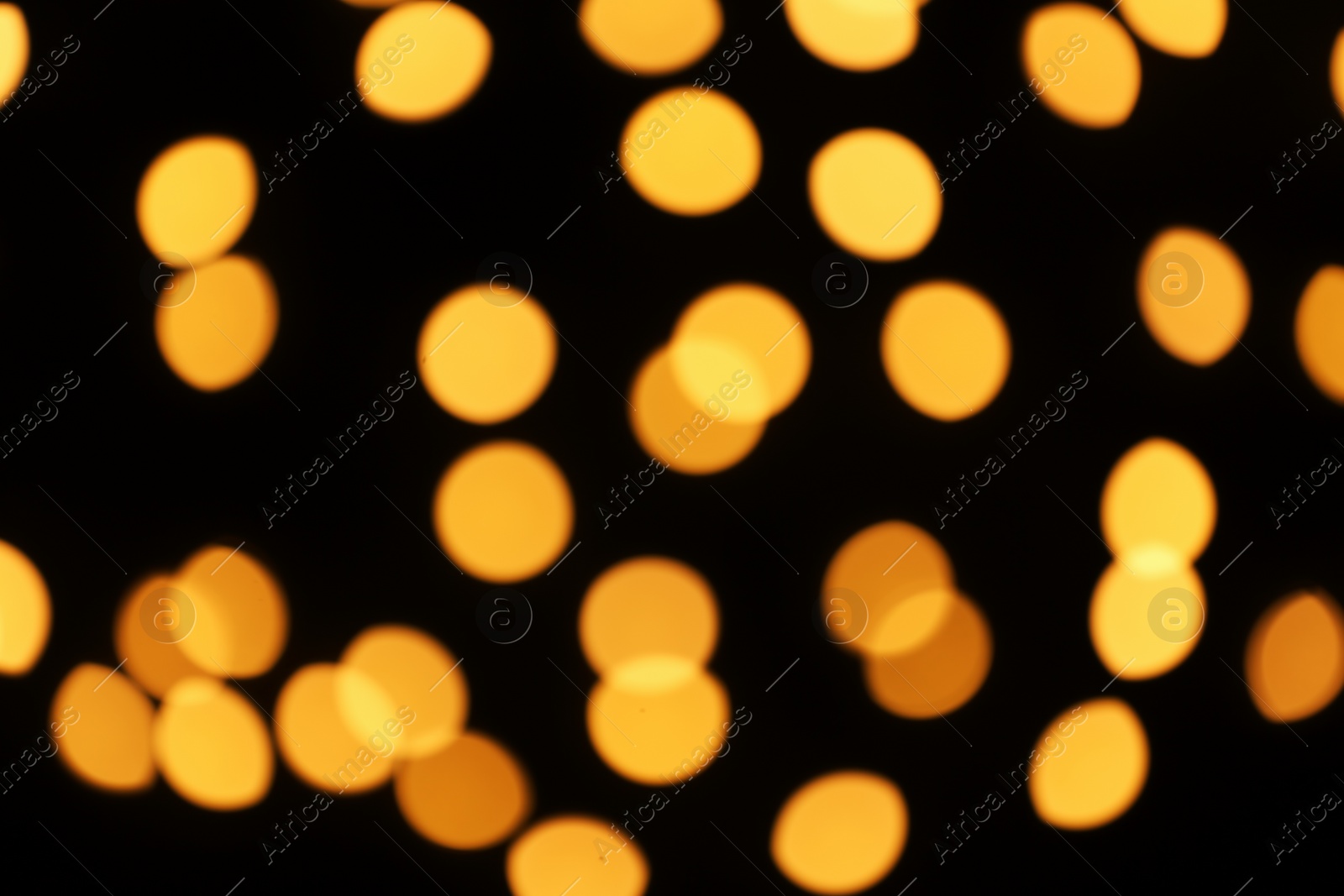 Photo of Beautiful golden lights on dark background. Bokeh effect