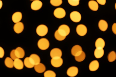 Photo of Beautiful golden lights on dark background. Bokeh effect