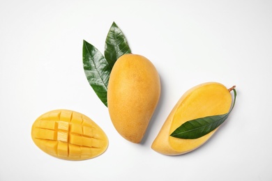 Composition with fresh mango fruits on white background, top view