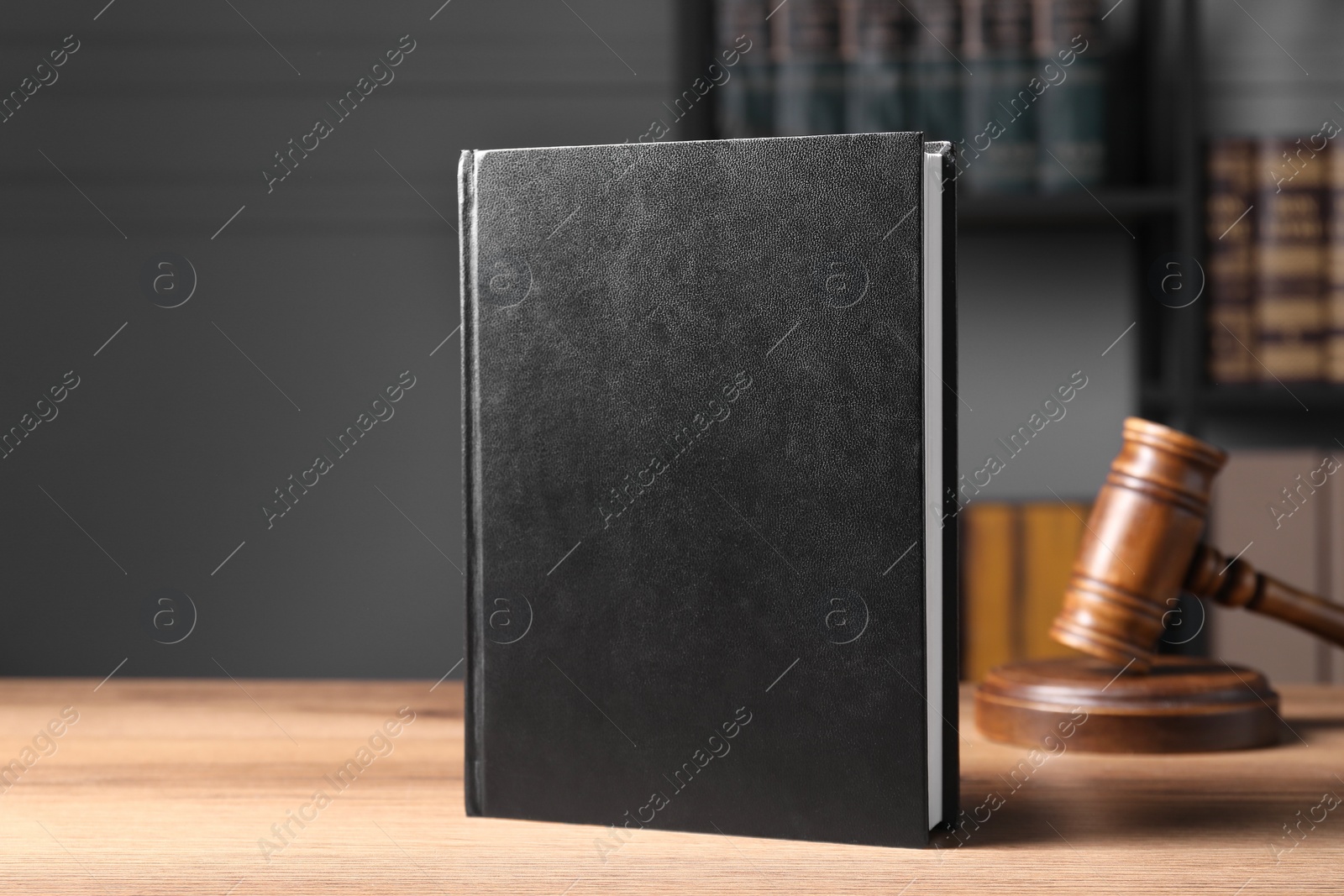 Photo of Law. Book and gavel on wooden table, space for text