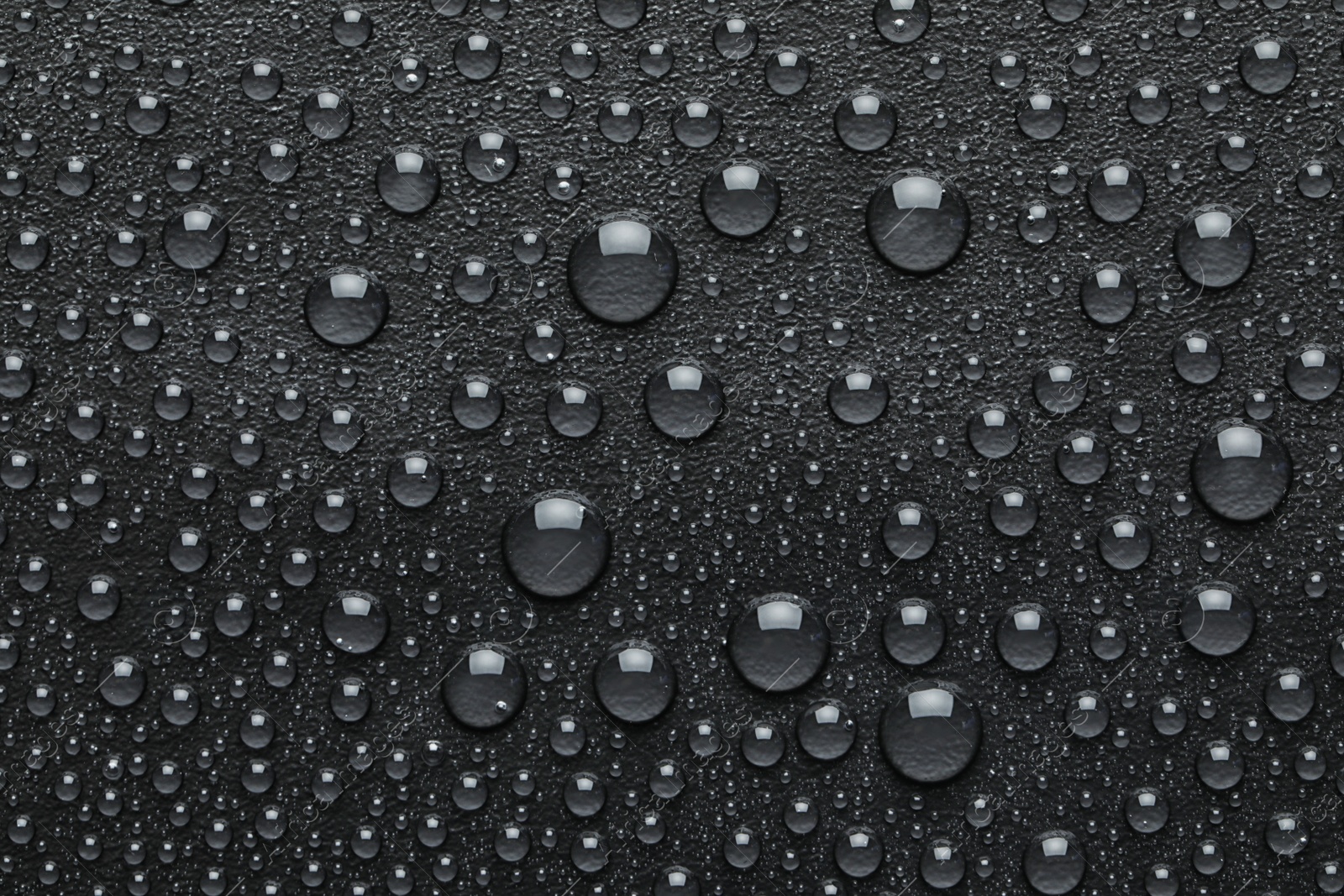 Photo of Water drops on black background, top view