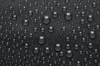 Photo of Water drops on black background, top view