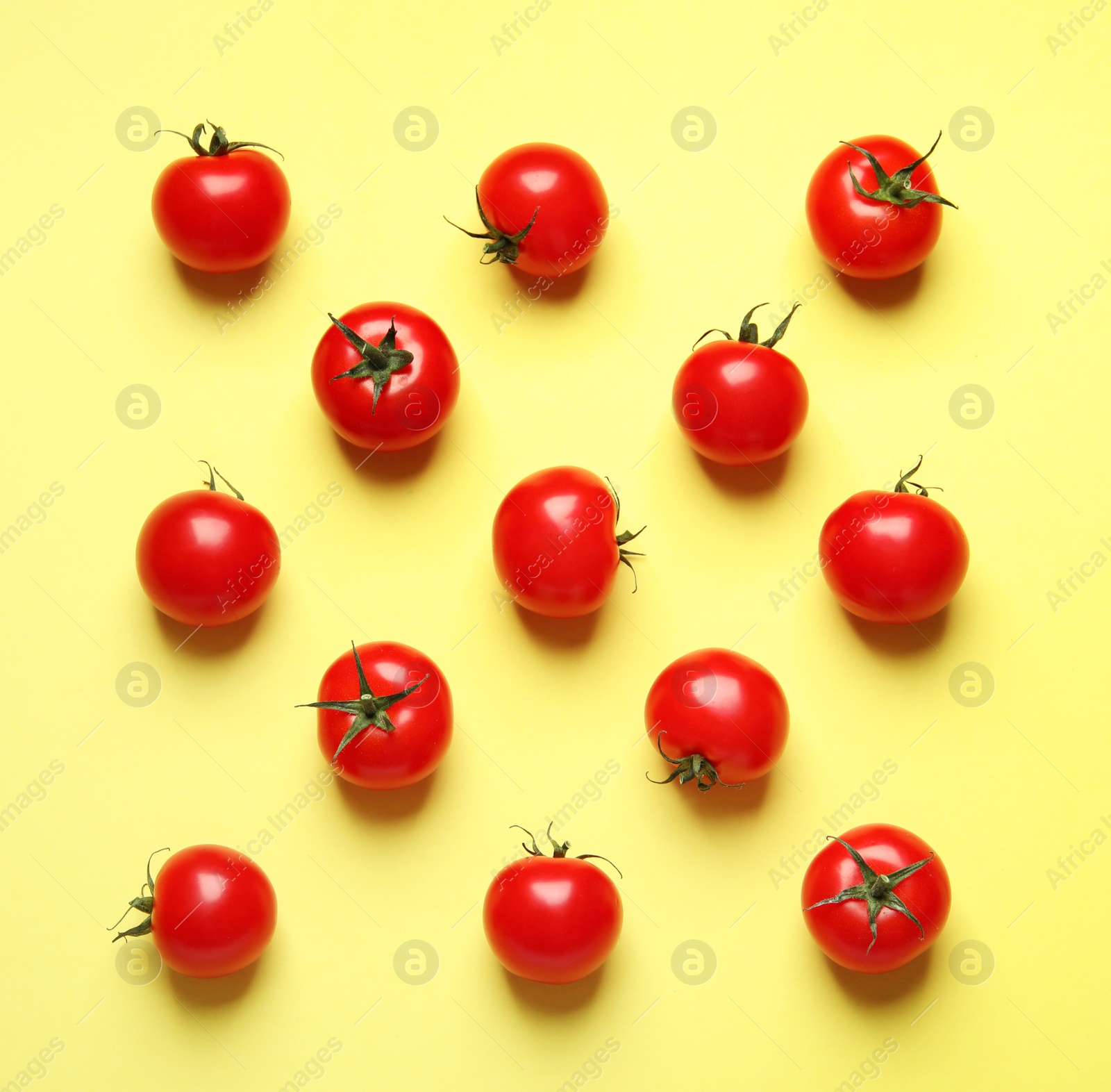 Photo of Flat lay composition with cherry tomatoes on color background