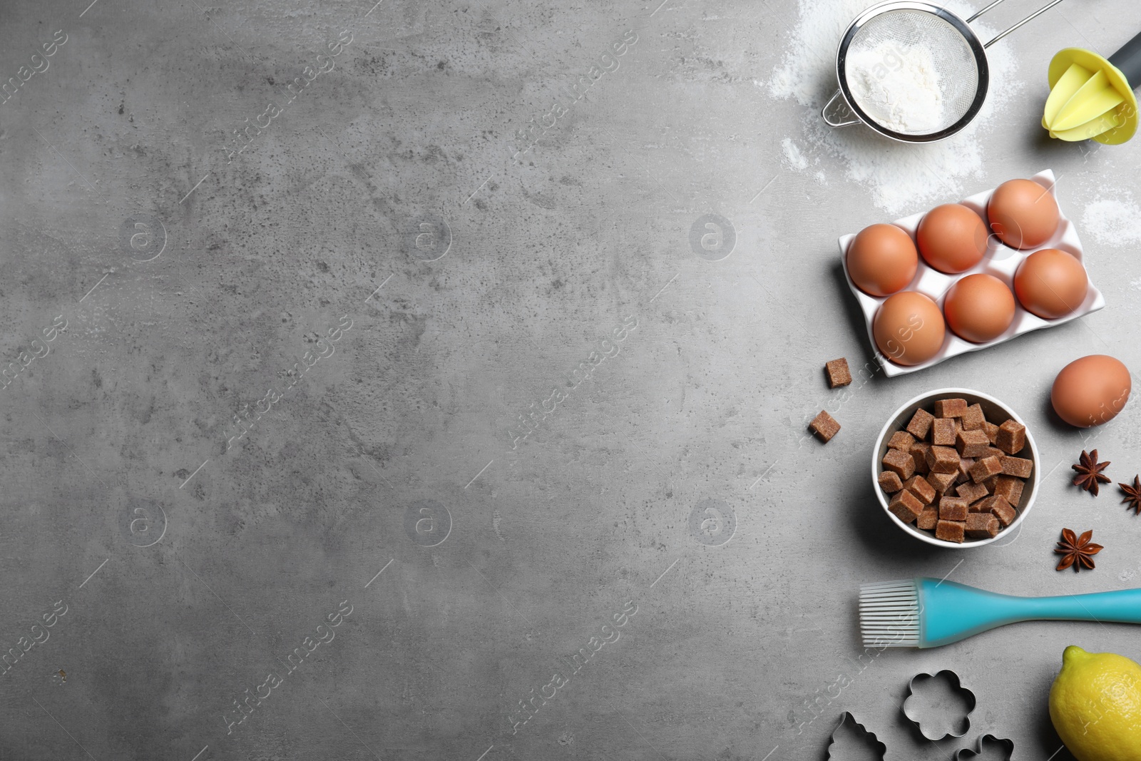 Photo of Cooking utensils and ingredients on grey table, flat lay. Space for text