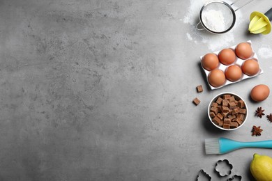 Cooking utensils and ingredients on grey table, flat lay. Space for text