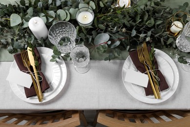 Luxury table setting with beautiful decor and blank cards. Festive dinner